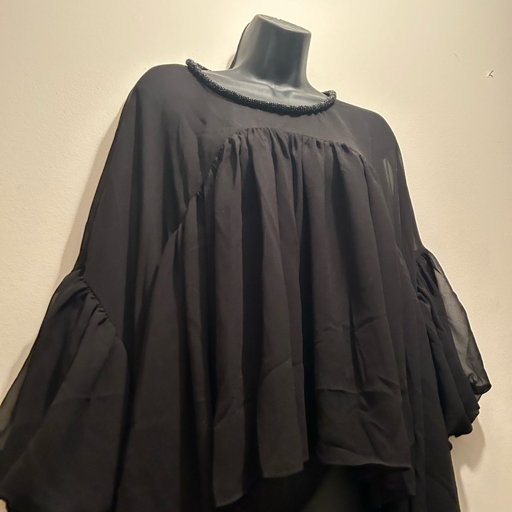Sheer black high low shirt with bubble sleeve and embellishment neckline